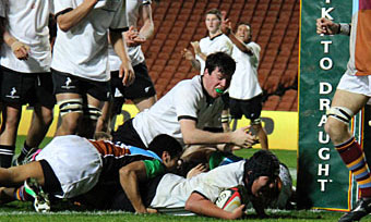 Prop Masashi Sumino scores the match-sealing try near the posts, to the obvious delight of lock Keeghan Grey.